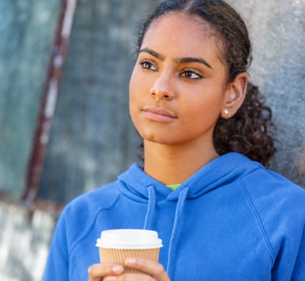Thoughtful women holding coffee